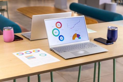 Coworking laptop displaying colorful data dashboard and charts for analytics and presentations