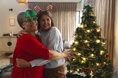 Senior Mother and Daughter Celebrating Christmas in Cozy Living Room