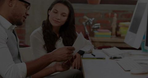 Office collaboration examining documents at workplace