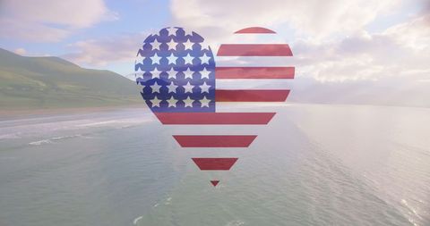 Heart Shaped American Flag Over Ocean and Sunny Beach
