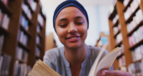 Smiling Asian Student in Hijab Studying in Library