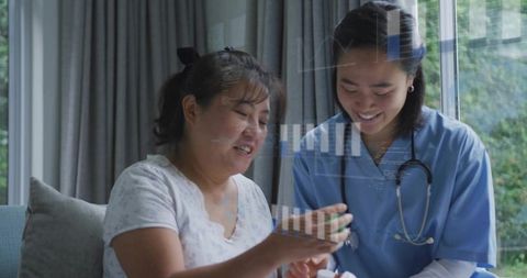 Nurse assisting patient with medication management at home on sofa, caring support