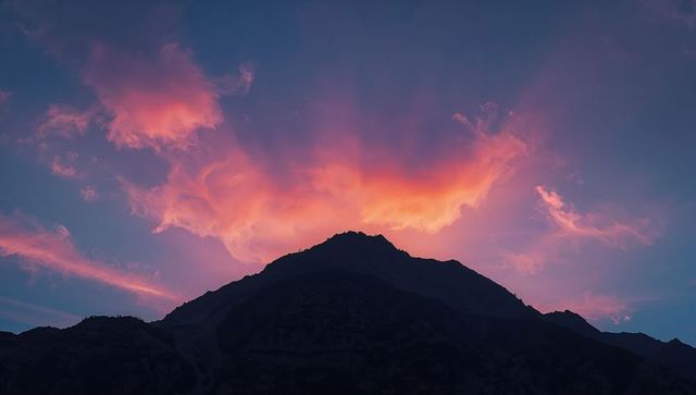 Mountain Silhouette at Dusk with Glowing Cloudscape