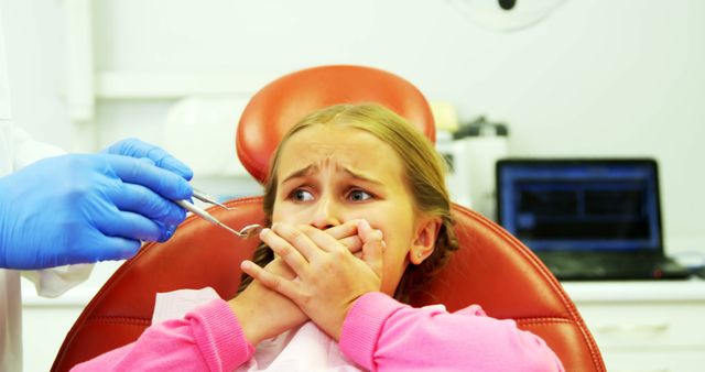 Young patient scared during a dental check-up at clinic