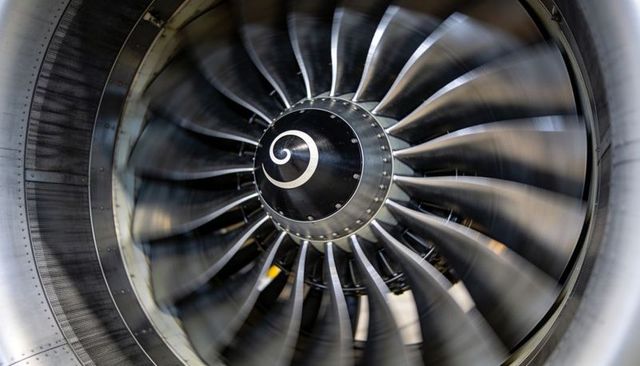 High-speed turbofan rotor spinning inside aircraft engine nacelle with spiral spinner