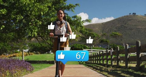 Young Woman Enjoying Electric Scooter Ride with Social Media Likes