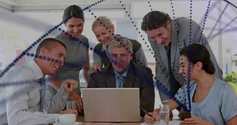 Business team collaborating over laptop while manager leading strategy review in office
