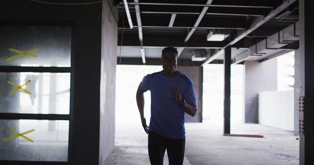 Focused Sportsman Running through Urban Industrial Space - Download Free Stock Images Pikwizard.com