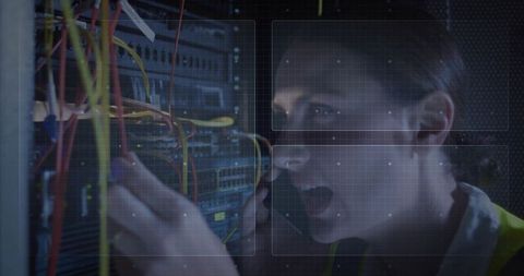 Technician repairing server rack cables in datacenter with network monitoring overlay