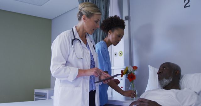 Diverse female doctor talking to male patient in hospital bed - Download Free Stock Photos Pikwizard.com