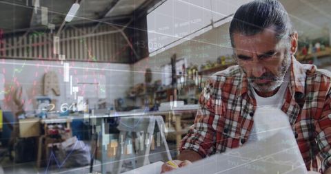 Business Analyst Reviewing Data Amidst Statistics Graphics Overlay