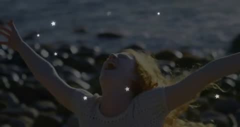 Joyful Woman Embracing Nature at Rocky Seaside at Sunrise