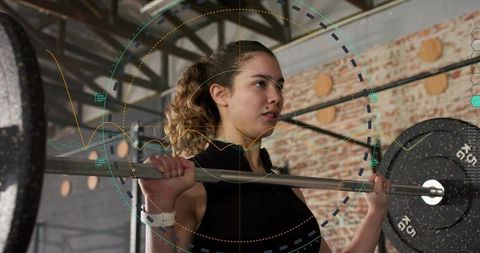 Young woman performing barbell squat with performance hud overlay in industrial gym