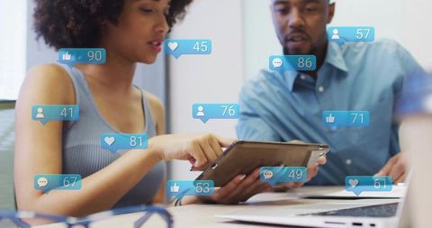 Business Professionals Analyzing Data on Tablet with Social Metrics Overlays