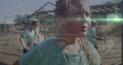 Adventurous child running through muddy obstacle course