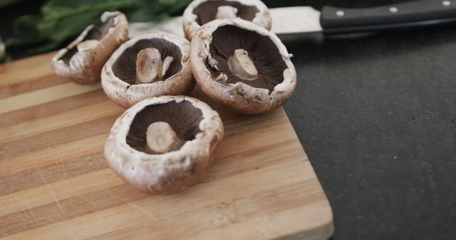 Fresh Mushrooms on Wooden Cutting Board with Knife in Kitchen - Download Free Stock Images Pikwizard.com