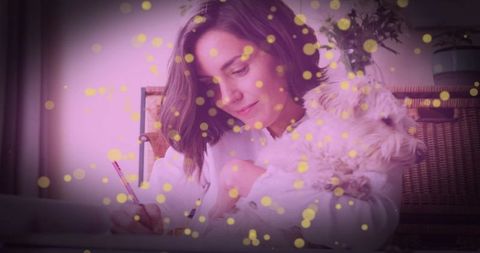 Creative writing at home with dog under decorative lights