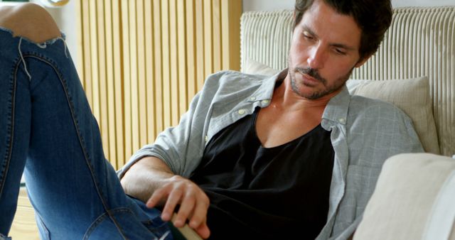 Relaxed Man Scrolling on Phone at Home in Casual Clothes - Download Free Stock Images Pikwizard.com