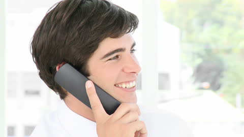Young Professional Smiling While on a Phone Call in Office