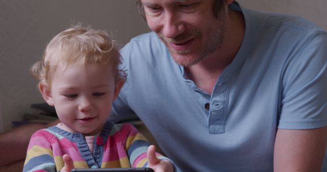 Father Bonding with Toddler Playing on Tablet at Home - Download Free Stock Images Pikwizard.com