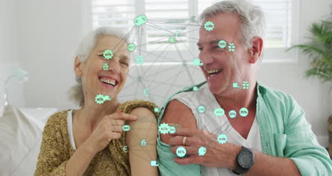 Senior Couple Smiling After Vaccination With Digital Interface