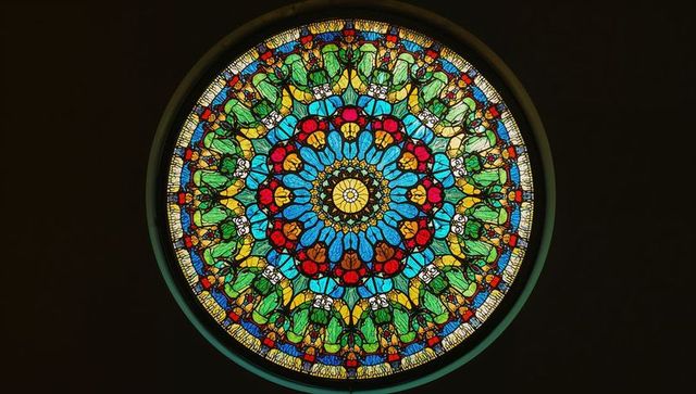 Circular Stained Glass Window with Vibrant Colors in Historic Setting