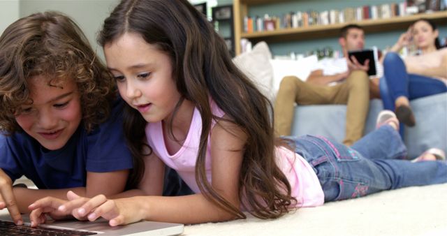 Children Using Laptop While Parents Relax on Sofa - Download Free Stock Images Pikwizard.com