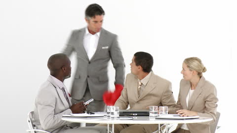 Manager with Boxing Gloves Confronting Team in Office Meeting