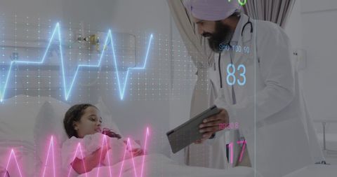 Asian Male Doctor with Young Patient in Hospital Bed Monitoring Vital Signs