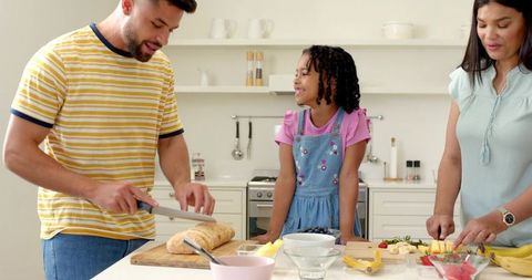 Diverse family enjoying cooking together in modern kitchen