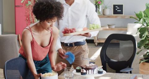 Office celebration preparation with cakes and decorations