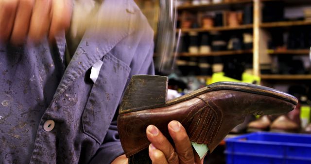 Shoemaker carefully crafting leather shoes using a hammer in a workshop. This image is ideal for use in articles or content about traditional crafts, handmade items, skilled trades, manufacturing processes, and the importance of artisanal work. It highlights the craftsmanship and precision involved in making high-quality footwear.