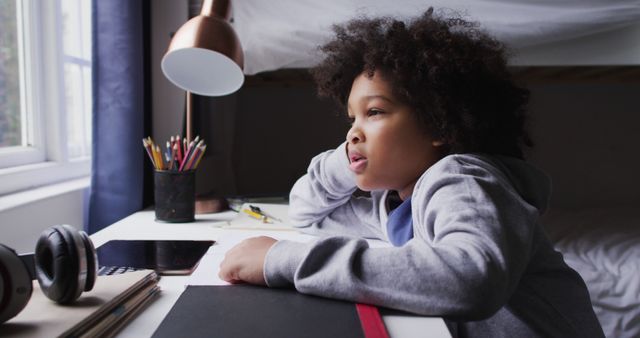 Curious Child Daydreaming While Sitting at Desk Near Window - Download Free Stock Images Pikwizard.com