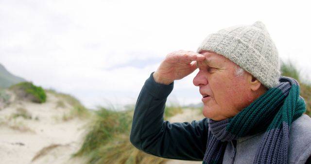 Elderly Man Enjoying Day at Windy Beach in Winter Gear - Download Free Stock Images Pikwizard.com