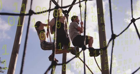 Three friends conquering high rope adventure course outdoors