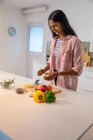 Indian Woman Preparing Vegetables on Modern Kitchen Island