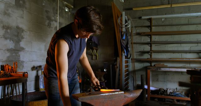 Young Male Blacksmith Working Metal in Workshop - Download Free Stock Images Pikwizard.com