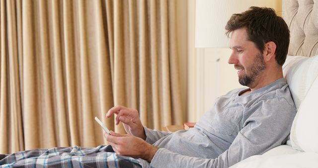 Man Relaxing in Bed Using Tablet at Home - Download Free Stock Images Pikwizard.com