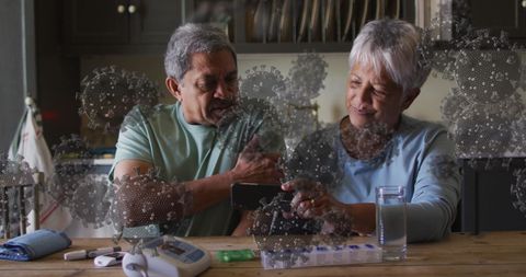 Senior couple engaging with technology amidst pandemic concept