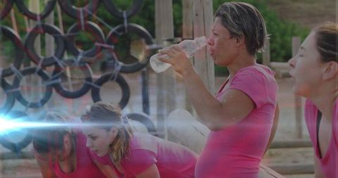 Athletes refreshing at outdoor obstacle course