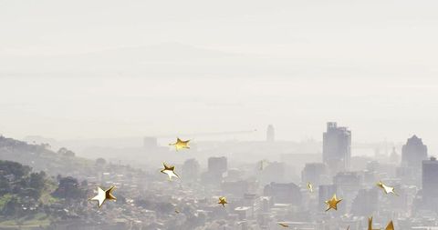 Misty Cityscape with Golden Star Overlays Adding Magical Charm