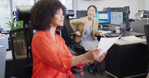 Colleagues Discussing Project at Modern Office Desk