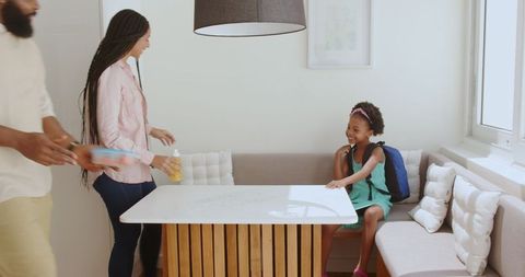 Family preparing school backpack morning routine