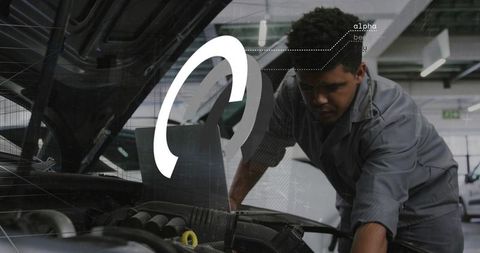 Mechanic inspecting car engine with diagnostic HUD overlay in modern workshop
