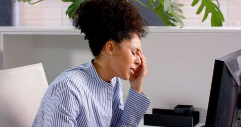 Stressed Businesswoman Overcoming Challenges at Work Desk