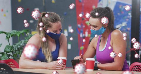 women in gym cafeteria using phone with virus cells overlay - Download Free Stock Images Pikwizard.com