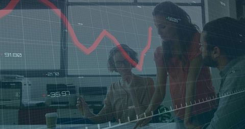 Team collaborating over financial report with red trend graph overlay in modern office
