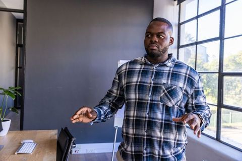 Professional African American Man Presenting in Modern Office