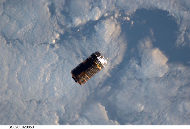 The unpiloted Japanese Kounotori2 H-II Transfer Vehicle (HTV2) glides against a backdrop of Earth’s cloud cover as it approaches the International Space Station in January 2011. Launched by the Japan Aerospace Exploration Agency (JAXA) from the Tanegashima Space Center, this spacecraft carries over four tons of essential food and supplies for the ISS crew. This image can be used to depict space missions, Japanese aerospace advancements, international cooperation in space, and cargo shipments in the space industry.