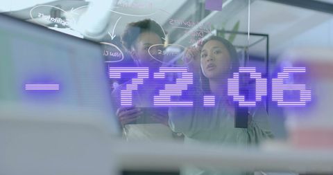 Diverse Colleagues Brainstorming with Financial Data Overlay